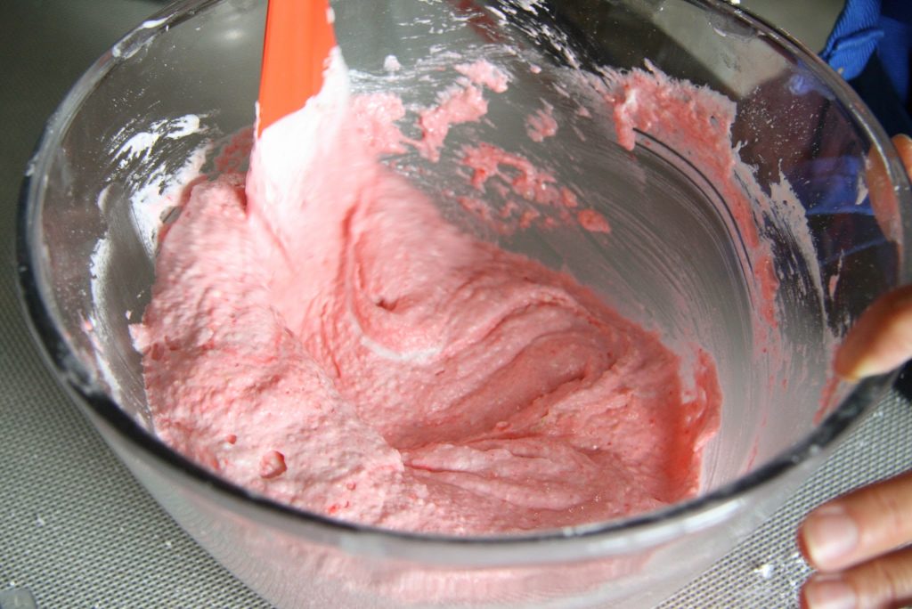 Incorporating meringue into the dry ingredients. 