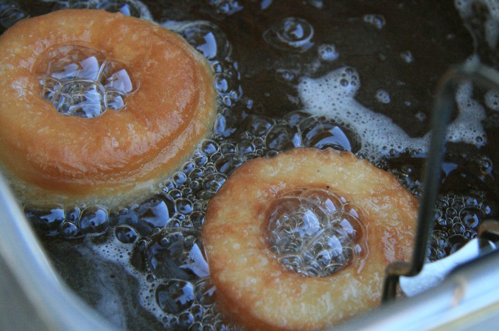 Two cronuts made differently being deep-fried. Top-left: Pillsbury, bottom-right: Dinner With Julie. Two cronuts made differently being deep-fried. Top-left: a very dough-nut inflated Pillsbury, bottom-right: Wheel-like Dinner With Julie.