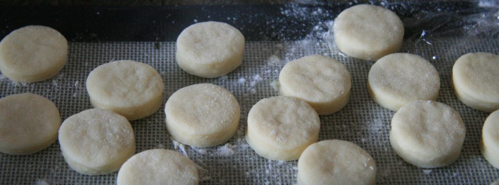Cronut-holes on a tray ready to be proofed, then deep-fried. Cronut-holes on a tray ready to be proofed, then deep-fried.