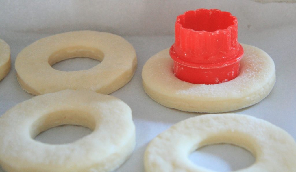 Use a small cookie cutter to cut out the holes in the donuts/cronuts. Use a small cookie cutter to cut out the holes in the donuts/cronuts.