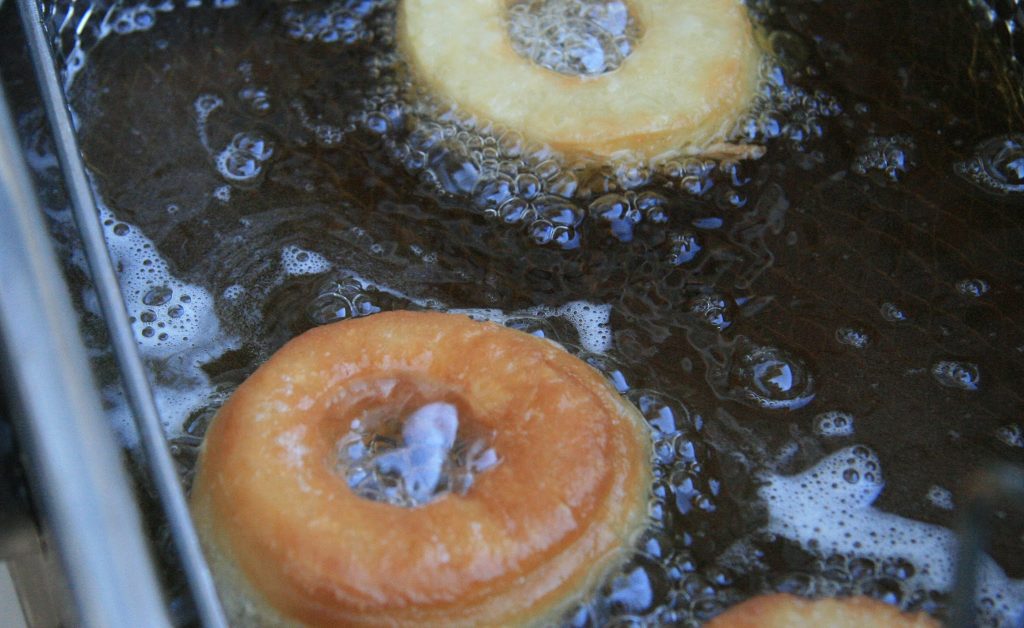 Two cronuts being deep fried: Top - Not Quite Nigella's, Bottom: Pillsbury. Two cronuts being deep fried: Top - Solid, Pineapple-looking Not Quite Nigella's, Bottom: Inflated-pillow-donut-like Pillsbury.