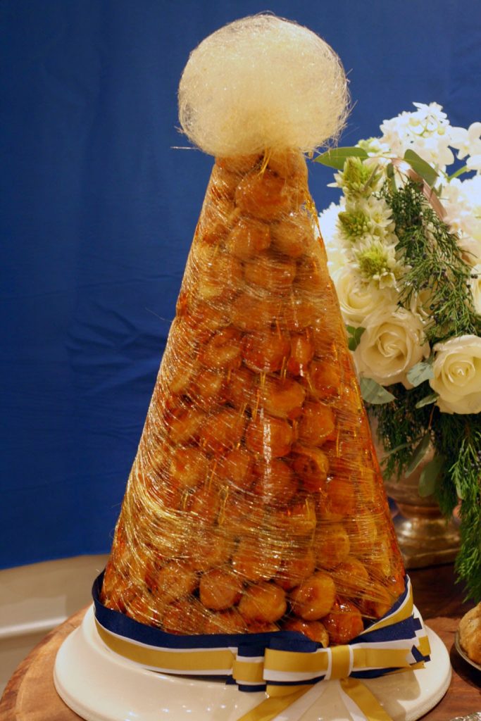 A mountain of Croquembouche wrapped in spun golden sugar threads.