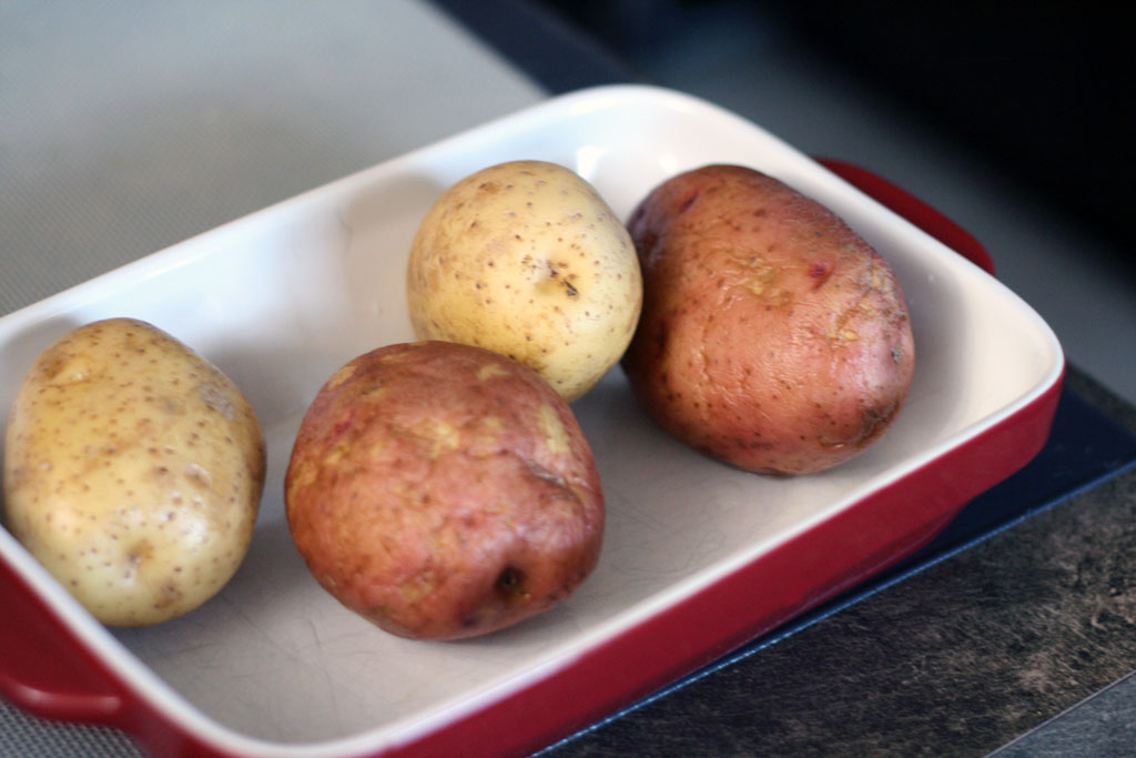4 Potatoes ready to be prepped. 4 potatoes scrubbed and ready to be prepped for hasselback potatoes.