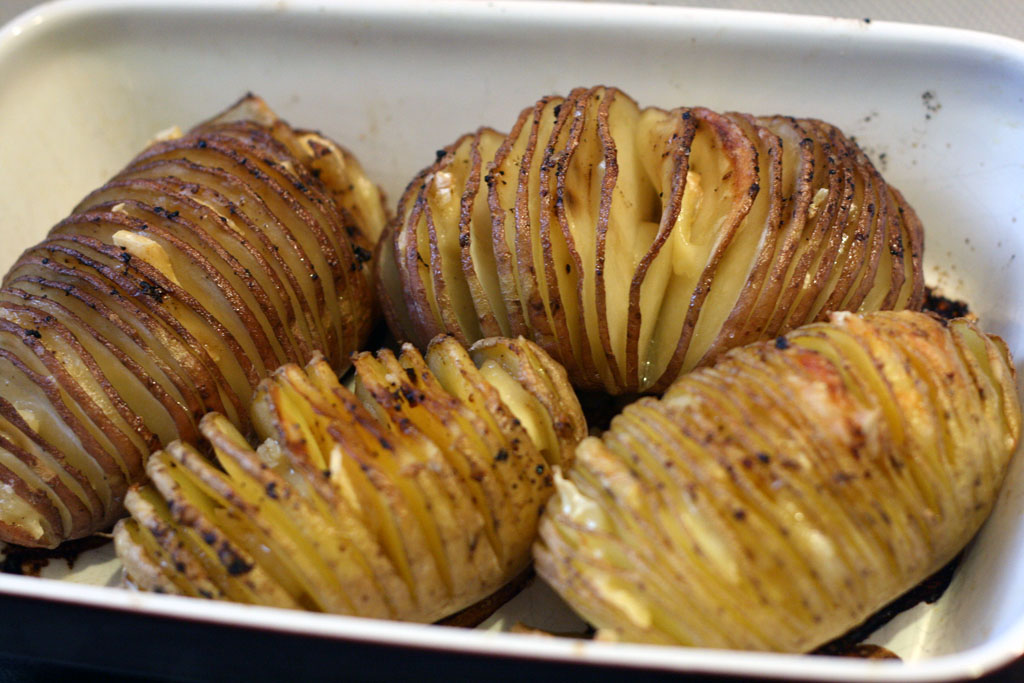 finished hasselback potatoes. Close-up of 4 hasselback potatoes baked.