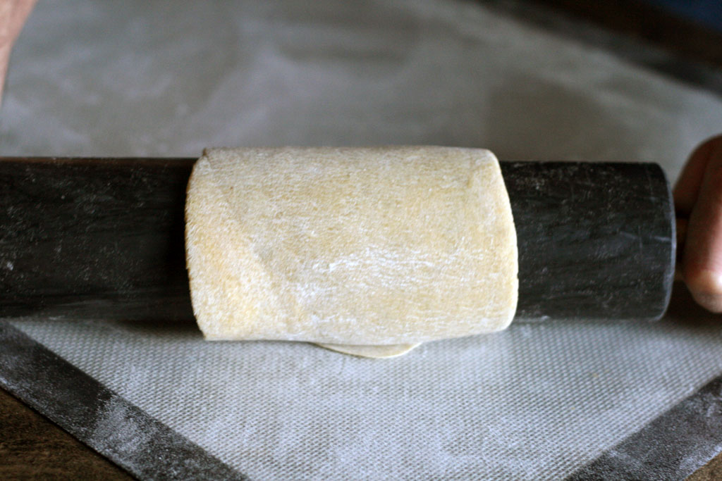 Ramen noodle dough wrapped around the rolling pin a few times.
