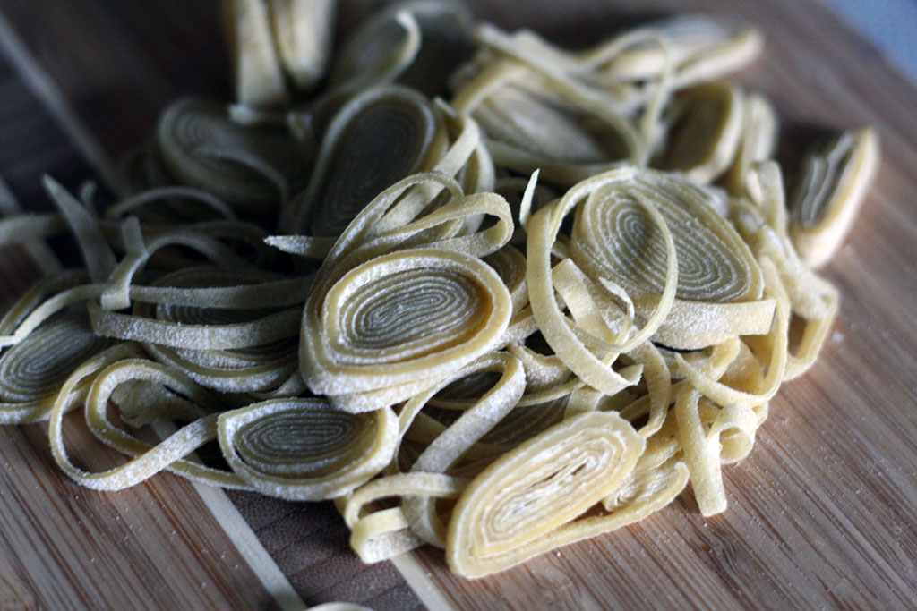 A pile of sliced spiral discs of rolled up ramen dough.