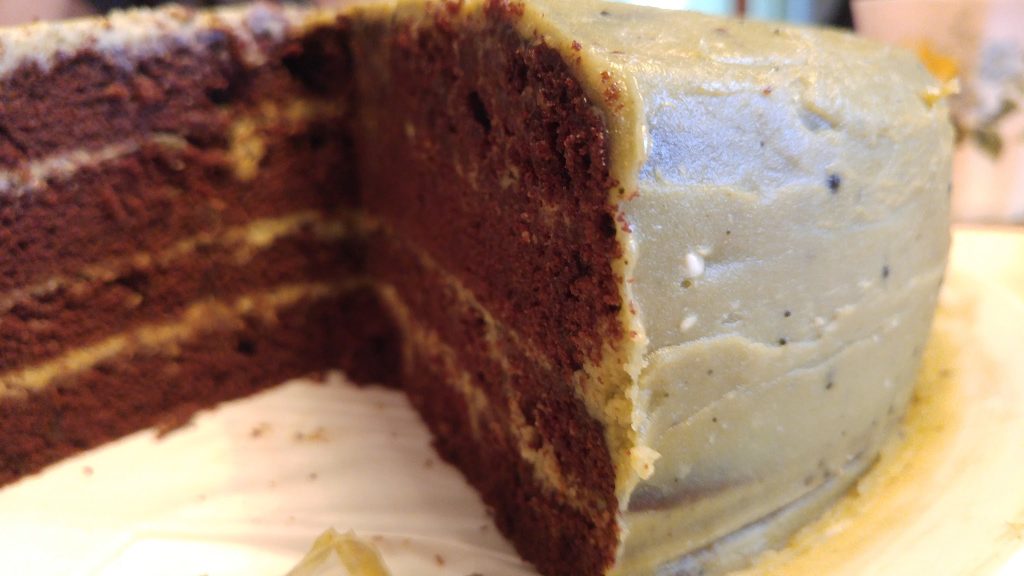 Inside a chocolate cake with matchabuttercream showing the layers of chocolate cake separated with buttercream