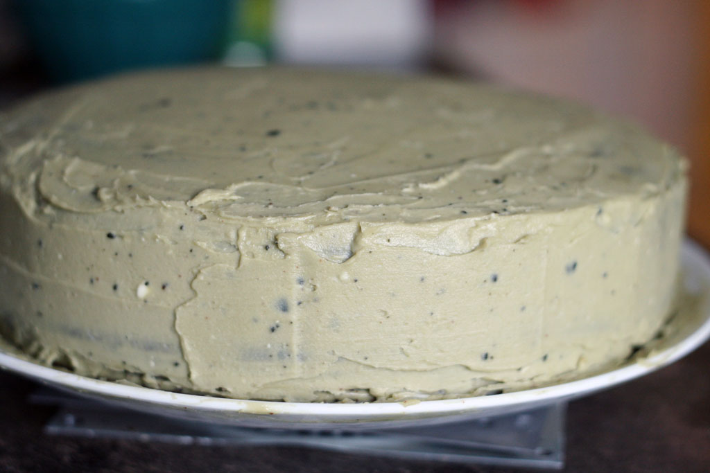 Sideview of a chocolate cake covered with matcha buttercream