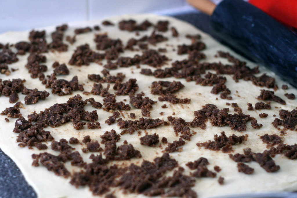 cinnamon dough rolled out with the filling on top