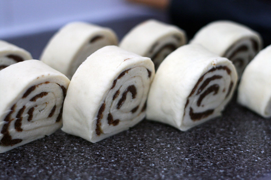 cinnamon rolls all cut standing upright on the counter