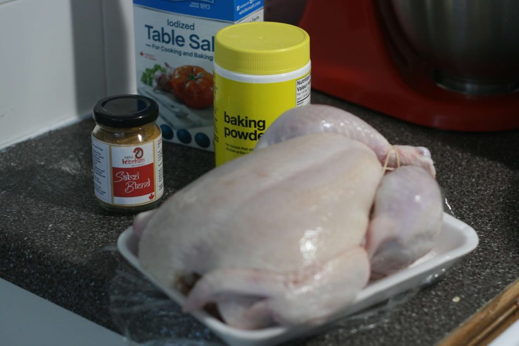 Turkey in foreground, sabzi spice blend, baking powder and table salt in background