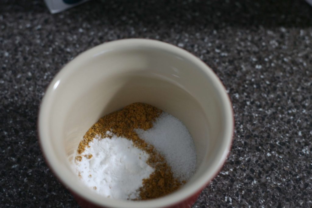 Bowl with baking powder, salt, and spice blend.