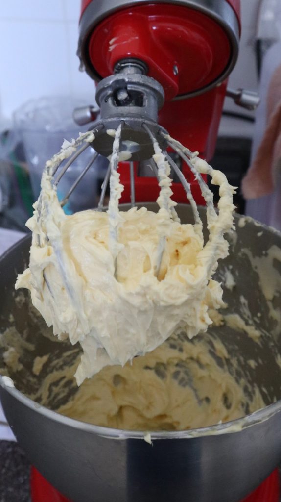 the buttercream on the whisk of the kitchen aid