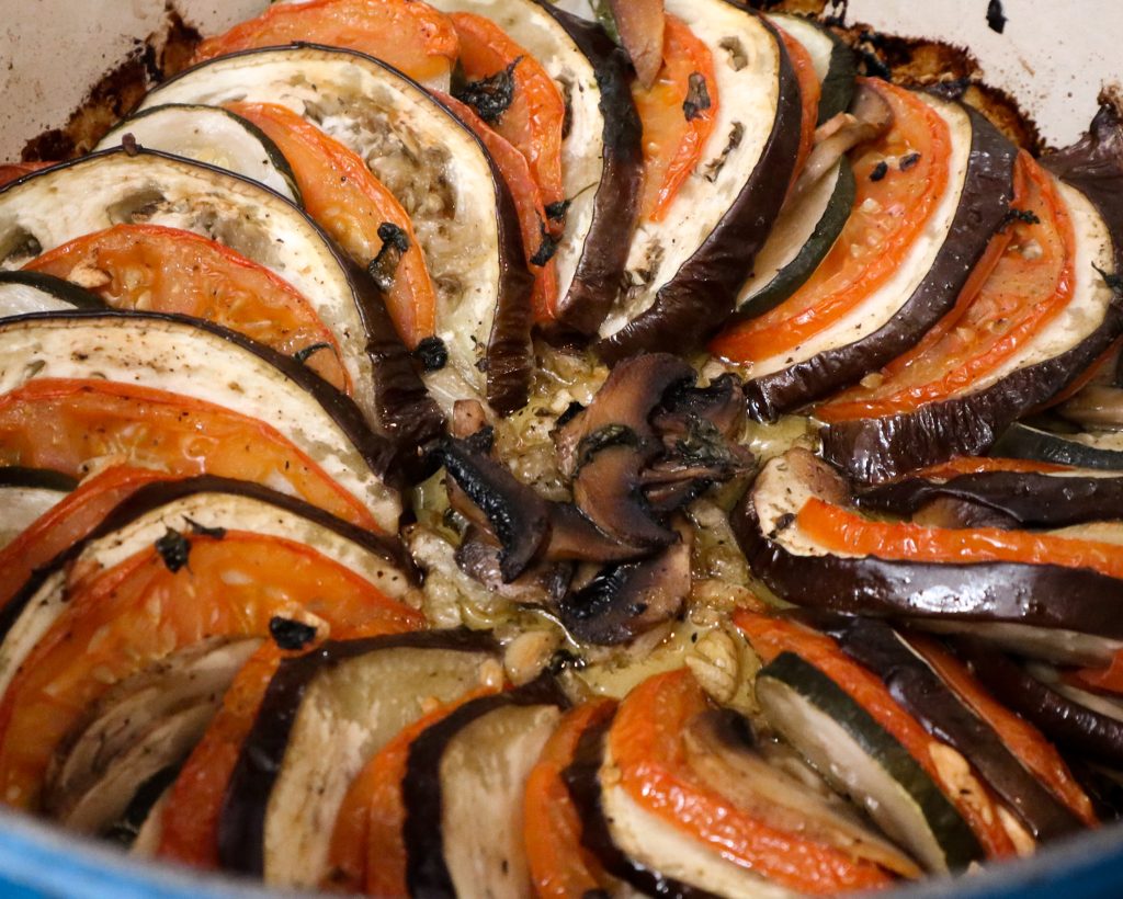 A baked tian showing caramelized eggplant, tomato, and zucchini softened in the oven.