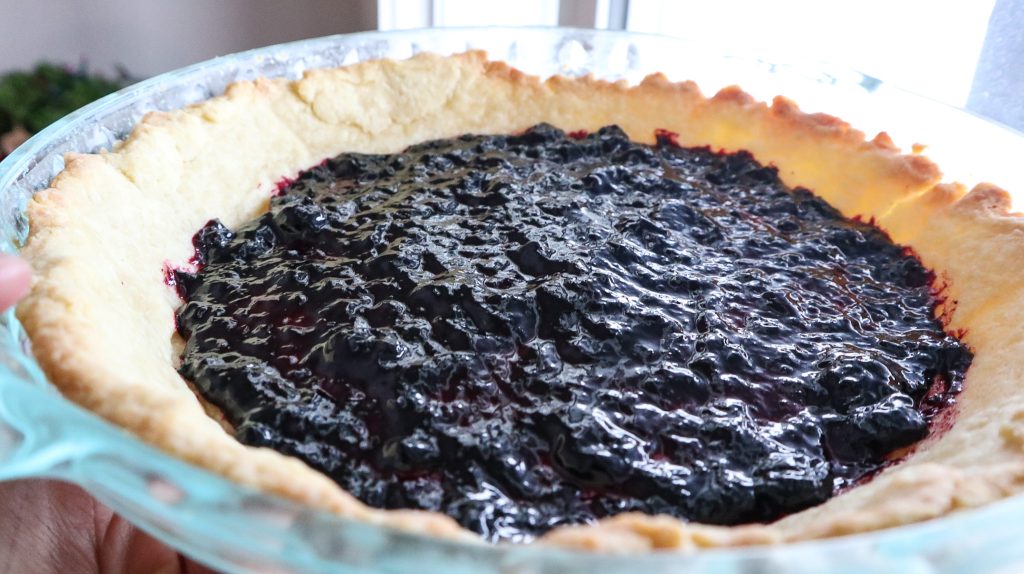 Haskap jam spread over the tart